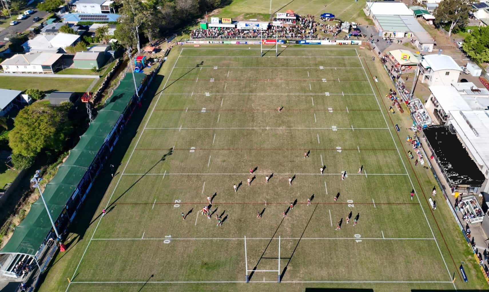 A drone view of a suburban rugby match mid-play